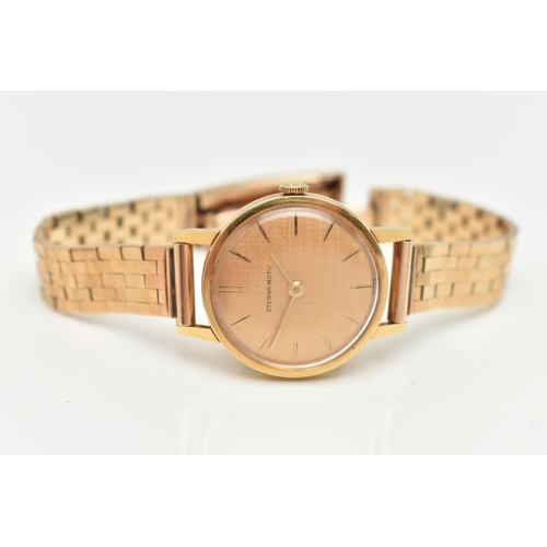 80 - A 9CT GOLD ETERNA MATIC WRISTWATCH, the textured champagne coloured dial, with gold coloured hourly ... 