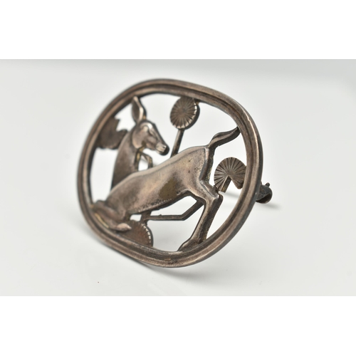 90 - A 'GEORG JENSEN' SILVER BROOCH, open work kneeling deer design in oval surround, measuring approxima... 