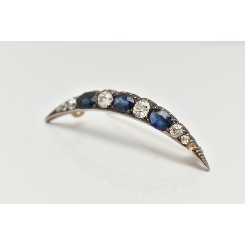 91 - A LATE VICTORIAN DIAMOND AND SAPPHIRE CRESCENT BROOCH, set with three oval cut blue sapphires, inter... 