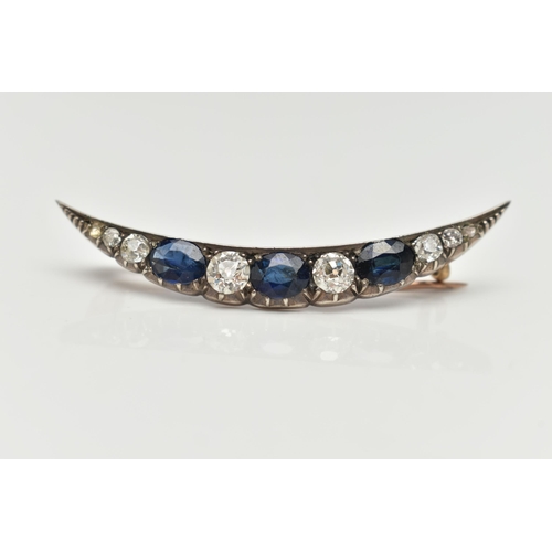 91 - A LATE VICTORIAN DIAMOND AND SAPPHIRE CRESCENT BROOCH, set with three oval cut blue sapphires, inter... 