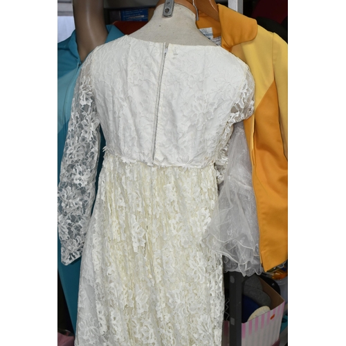 432 - A SHOP MANNEKIN AND THREE 1970S LADIES' OUTFITS, comprising a cream long sleeved lace wedding dress ... 