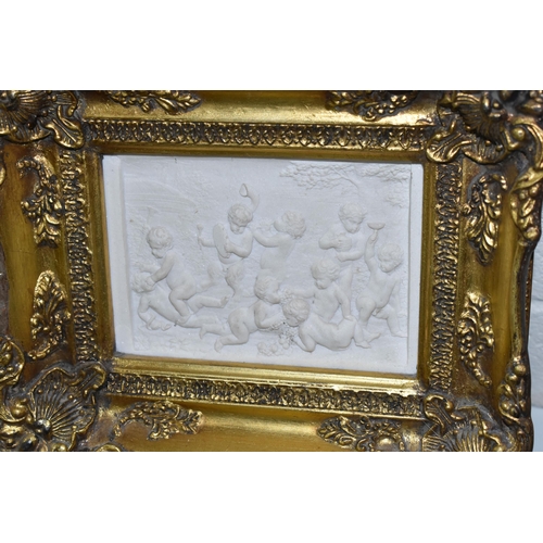 453 - THREE GILT FRAMED ITALIAN RECONSTITIUTED STONE PLAQUES, depicting Bacchanalian scenes of Putti, heig... 