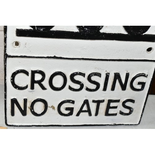 491 - A CAST IRON ROAD/RAILWAY SIGN 'Crossing No Gates', with stylised image of steam locomotive, white ba... 