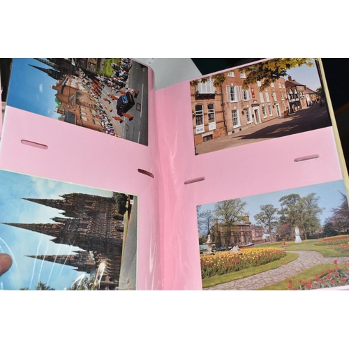 498 - FIVE ALBUMS OF POSTCARDS containing approximately 545 examples of places, streets, buildings, the ca... 