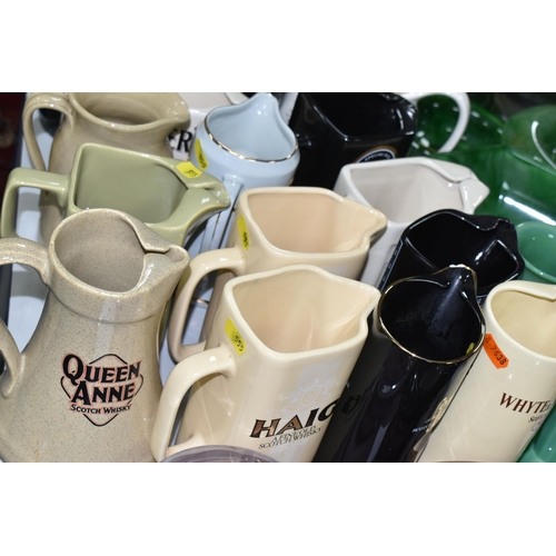 555 - WHISKY ADVERTISING JUGS, comprising a collection of nineteen jugs and two ashtrays, whisky names inc... 