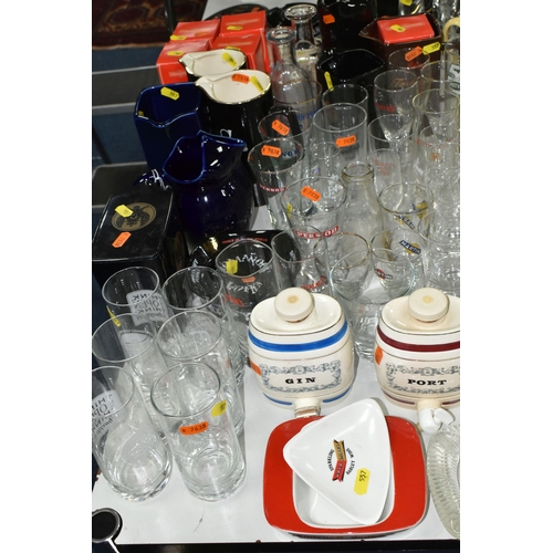 557 - A LARGE COLLECTION OF BREWERIANA, comprising glasses, water jugs, decanters and ashtrays, four boxed... 