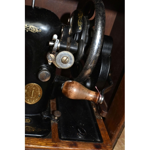 584 - THREE VICTORIAN SINGER SEWING MACHINES, comprising a Singer Model 66K sewing machine, decorated with... 