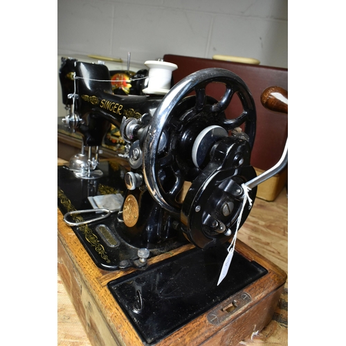 584 - THREE VICTORIAN SINGER SEWING MACHINES, comprising a Singer Model 66K sewing machine, decorated with... 