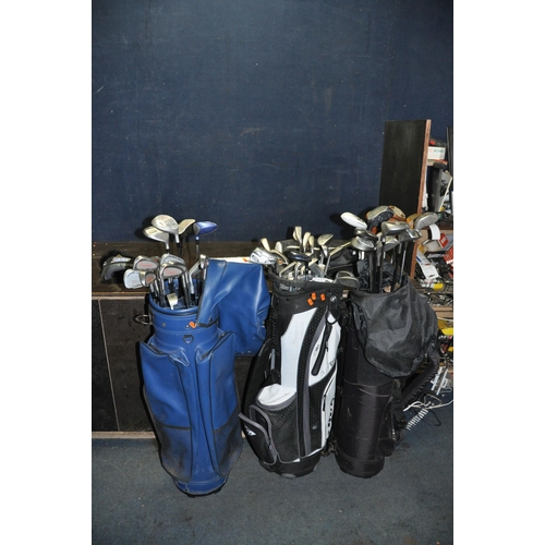 1063 - THREE GOLF BAGS CONTAINING TWENTY SEVEN IRONS, twenty one drivers and three putters from makers such... 