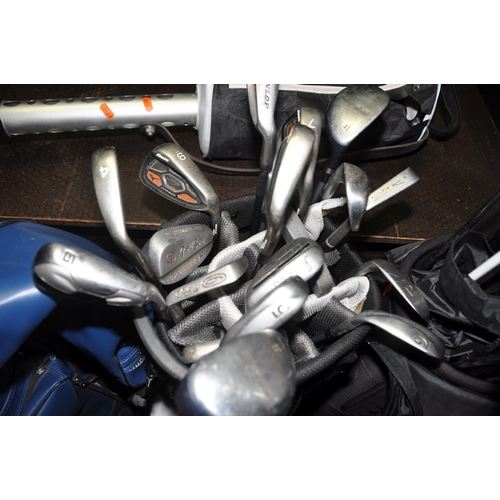 1063 - THREE GOLF BAGS CONTAINING TWENTY SEVEN IRONS, twenty one drivers and three putters from makers such... 