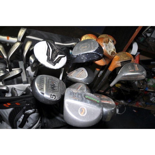 1063 - THREE GOLF BAGS CONTAINING TWENTY SEVEN IRONS, twenty one drivers and three putters from makers such... 