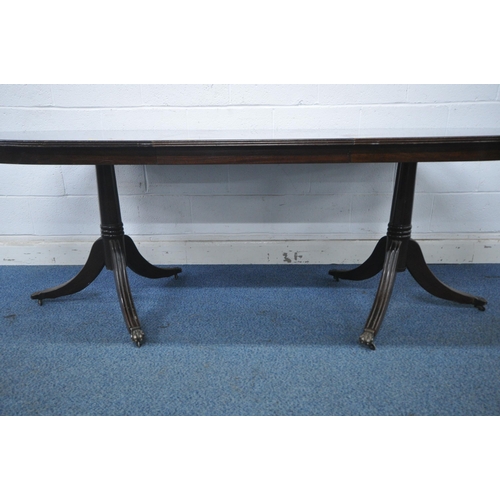 1206 - A 20TH CENTURY MAHOGANY TWIN PEDESTAL OVAL DINING TABLE, with one additional leaf, extended length 2... 