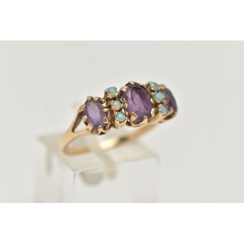 15 - A 9CT GOLD AMETHYST AND OPAL RING, set with three oval cut amethysts each claw set, interspaced with... 