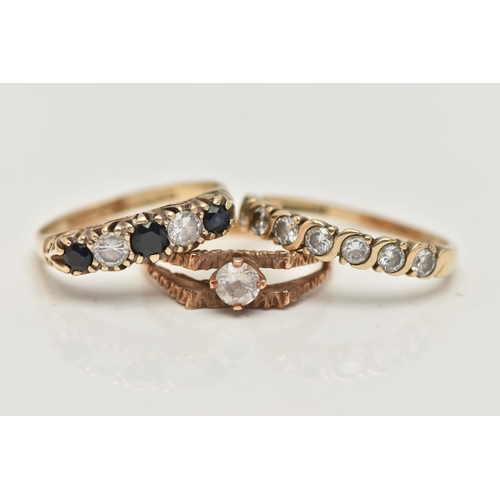 18 - THREE GEM SET RINGS, the first a 9ct gold colourless topaz single stone ring, textured bifurcated sh... 