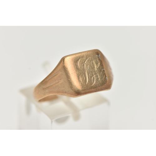 23 - A YELLOW METAL GENTS SIGNET RING, square polished signet, engraved monogram, textured tapering shoul... 