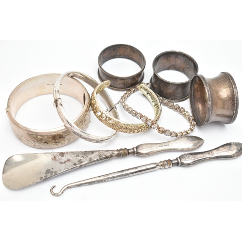 39 - SILVER BANGLES, NAPKIN RINGS AND OTHER ITEMS, to include a silver wide hinged floral bangle, push bu... 