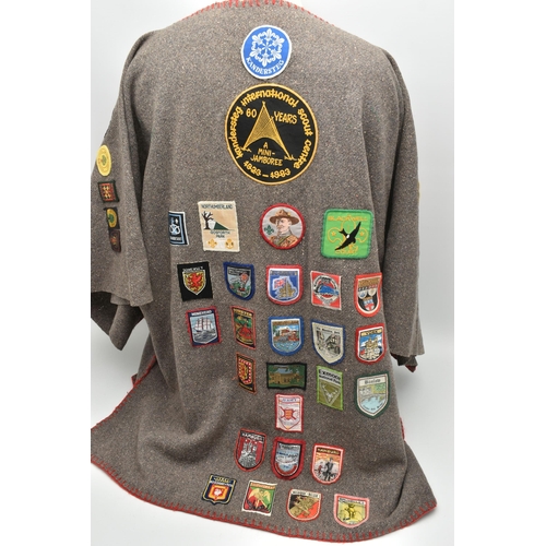 84 - THREE BLANKET PONCHOS WITH MAINLY GIRL GUIDE AND SCOUT BADGES, including two Kandersteg Internationa... 