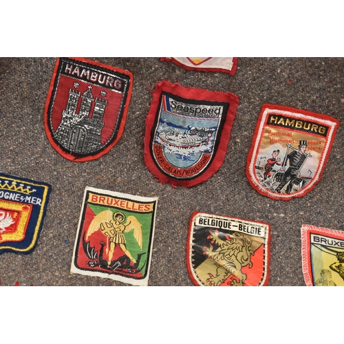 84 - THREE BLANKET PONCHOS WITH MAINLY GIRL GUIDE AND SCOUT BADGES, including two Kandersteg Internationa... 