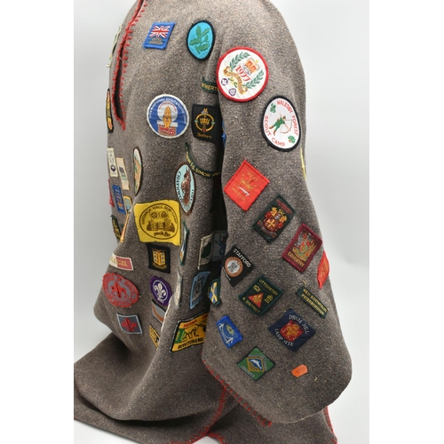 84 - THREE BLANKET PONCHOS WITH MAINLY GIRL GUIDE AND SCOUT BADGES, including two Kandersteg Internationa... 