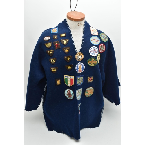 84 - THREE BLANKET PONCHOS WITH MAINLY GIRL GUIDE AND SCOUT BADGES, including two Kandersteg Internationa... 