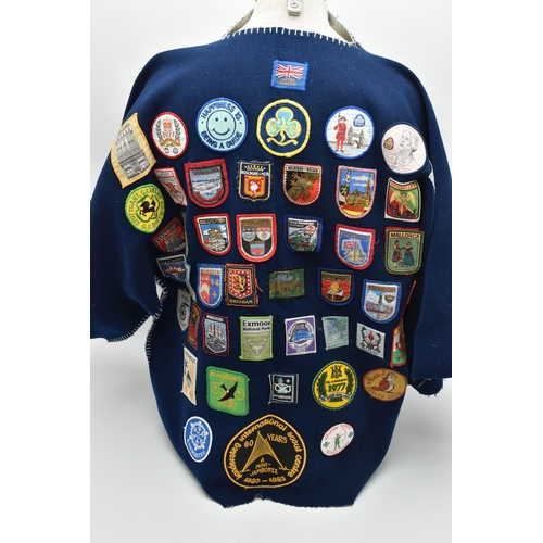 84 - THREE BLANKET PONCHOS WITH MAINLY GIRL GUIDE AND SCOUT BADGES, including two Kandersteg Internationa... 