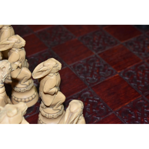 505 - A REYNARD THE FOX CHESS SET, resin figures in a cream and black colourway, approximate height of the... 