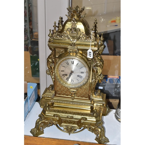 537 - A LATE 19TH CENTURY FRENCH BRASS MANTEL CLOCK, with a dome top with a coronet finial, surrounded by ... 