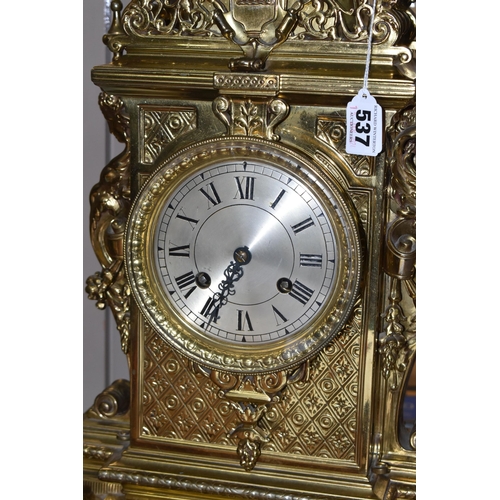 537 - A LATE 19TH CENTURY FRENCH BRASS MANTEL CLOCK, with a dome top with a coronet finial, surrounded by ... 