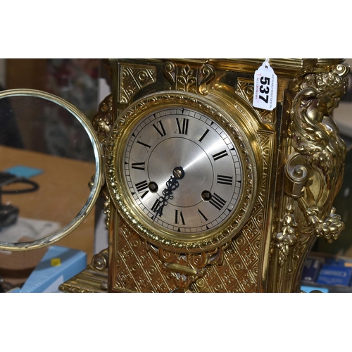 537 - A LATE 19TH CENTURY FRENCH BRASS MANTEL CLOCK, with a dome top with a coronet finial, surrounded by ... 