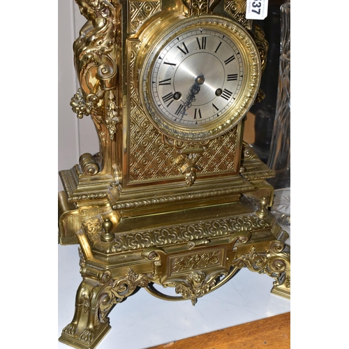 537 - A LATE 19TH CENTURY FRENCH BRASS MANTEL CLOCK, with a dome top with a coronet finial, surrounded by ... 