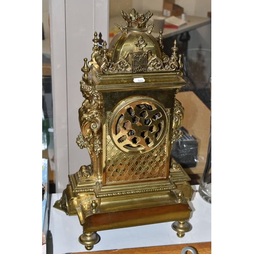 537 - A LATE 19TH CENTURY FRENCH BRASS MANTEL CLOCK, with a dome top with a coronet finial, surrounded by ... 