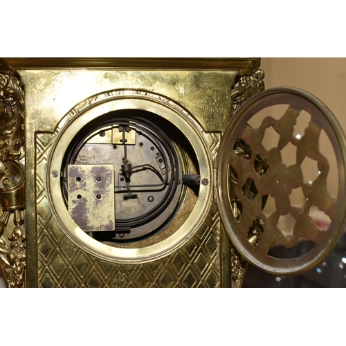 537 - A LATE 19TH CENTURY FRENCH BRASS MANTEL CLOCK, with a dome top with a coronet finial, surrounded by ... 