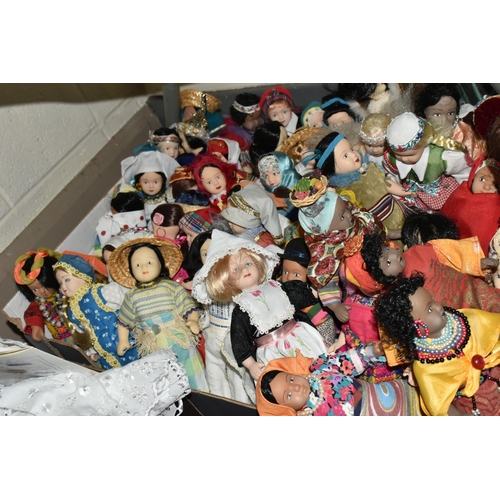 614 - THREE BOXES OF SOUVENIR DOLLS, to include a soft bodied porcelain baby doll marked 'Paul' 1986, thre... 