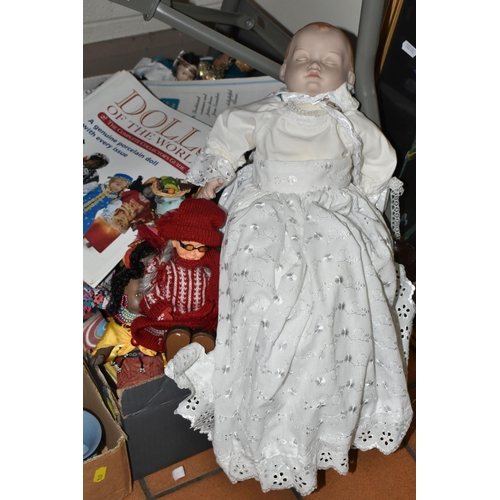 614 - THREE BOXES OF SOUVENIR DOLLS, to include a soft bodied porcelain baby doll marked 'Paul' 1986, thre... 