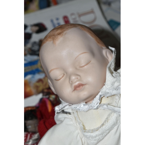 614 - THREE BOXES OF SOUVENIR DOLLS, to include a soft bodied porcelain baby doll marked 'Paul' 1986, thre... 