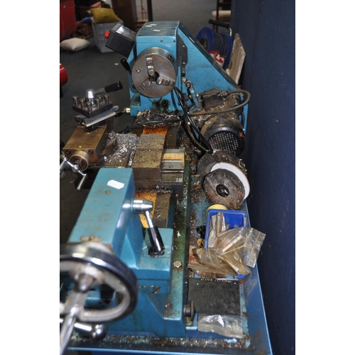 1110 - A CLARKE METALWORKER 6 speed lathe on stand with a three jaws chuck , 68cm bed, and some tools insid... 