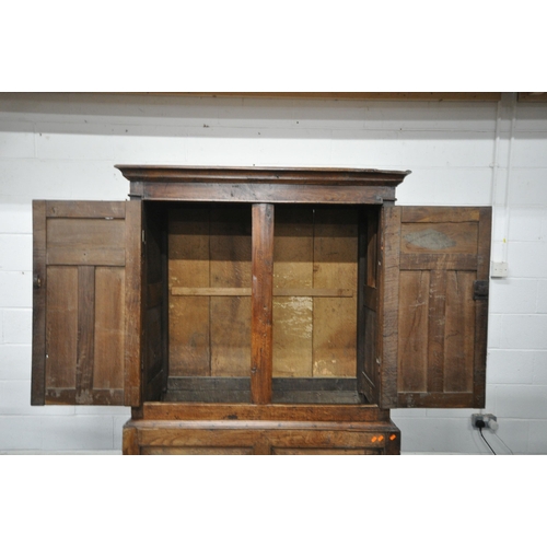 1324 - A 17TH CENTURY AND LATER OAK TWO DOOR CUPBOARD, the double fielded panel doors enclosing an open int... 