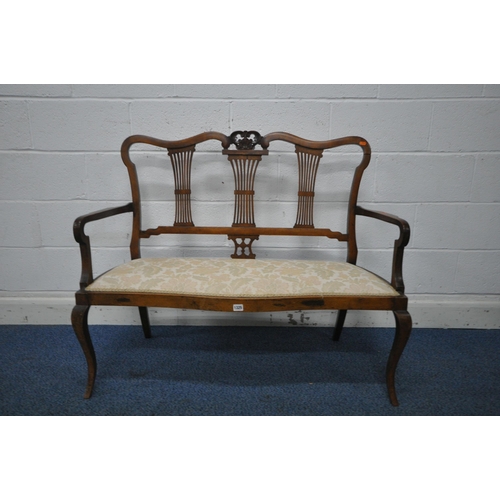 1325 - A VICTORIAN MAHOGANY SOFA, with wavy top and scrolled crest, three splat back supports, shaped open ... 