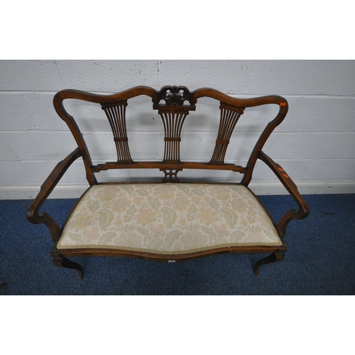 1325 - A VICTORIAN MAHOGANY SOFA, with wavy top and scrolled crest, three splat back supports, shaped open ... 