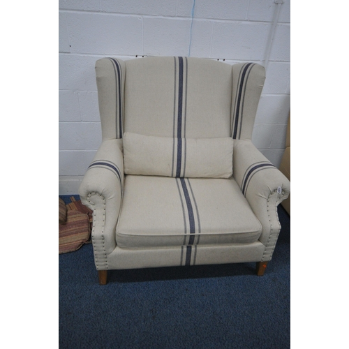 1327 - A COX & COX MODEL ANA OVERSIZED WINGBACK ARMCHAIR, with beige upholstery and blue stripes, on Limed ... 