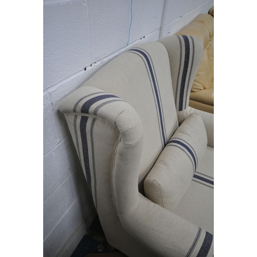 1327 - A COX & COX MODEL ANA OVERSIZED WINGBACK ARMCHAIR, with beige upholstery and blue stripes, on Limed ... 