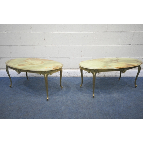 1200 - A PAIR OF ONYX AND BRASS OVAL COFFEE TABLES, bases with foliate detail on cabriole legs, length 98cm... 