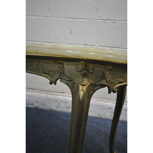 1200 - A PAIR OF ONYX AND BRASS OVAL COFFEE TABLES, bases with foliate detail on cabriole legs, length 98cm... 