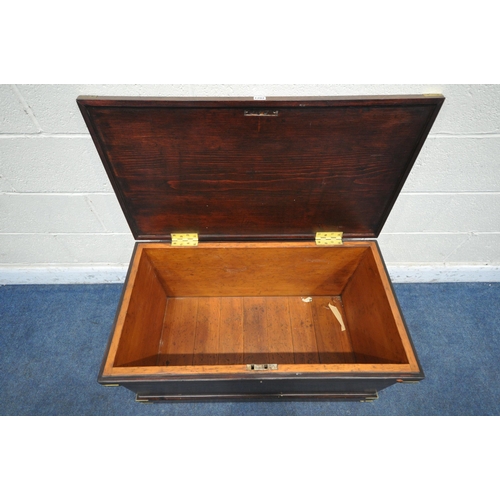 1202 - A STAINED PINE CAMPAIGN BLANKET BOX, with a hinged lid, twin brass handles and banding, width 95cm x... 