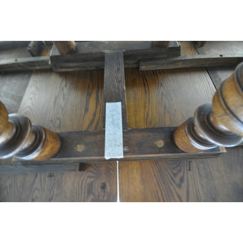 1208 - A FRENCH STYLE OAK EXTENDING DINING TABLE, with two additional leaves, raised on four turned legs, u... 