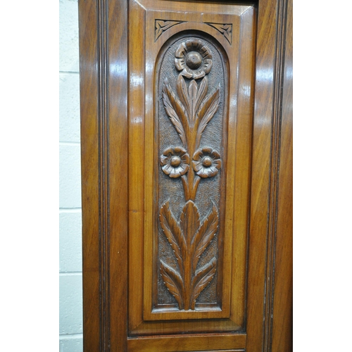 1212 - AN EARLY 20TH CENTURY WALNUT SINGLE MIRROR DOOR WARDROBE, with foliate and pokerwork panels, above t... 