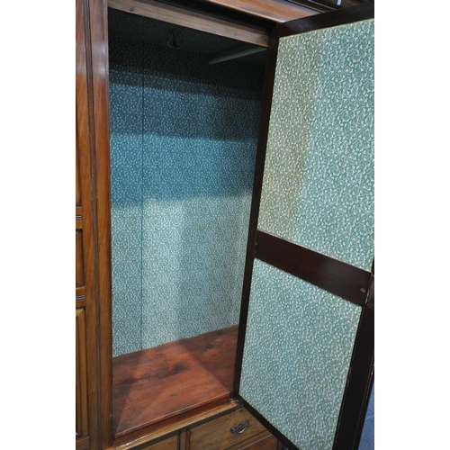 1212 - AN EARLY 20TH CENTURY WALNUT SINGLE MIRROR DOOR WARDROBE, with foliate and pokerwork panels, above t... 