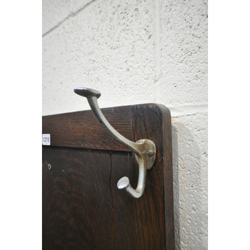 1215 - A 20TH CENTURY OAK HALL STAND, fitted with six coat hooks, surrounding a shelf, above a hinged stora... 