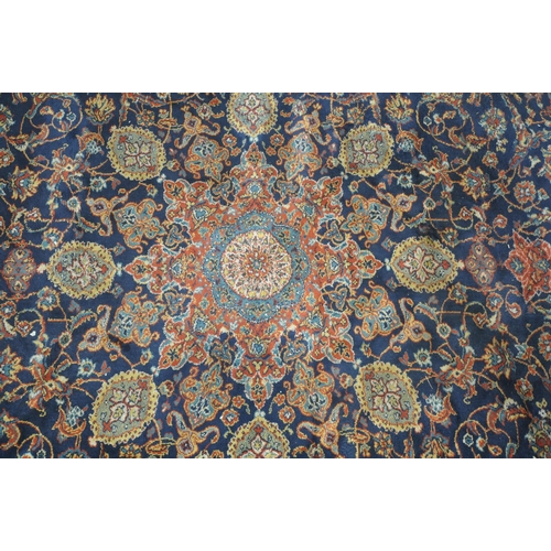 1224 - A 20TH CENTURY WOOLEN RUG, with repeating foliate design, central medallion, within a blue field, su... 