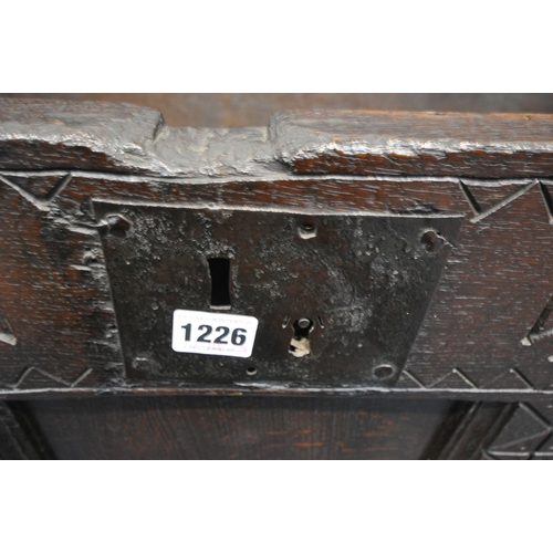 1226 - A 16TH/17TH CENTURY OAK PANELLED COFFER, with geometric pattern and repeating symbols, width 109cm x... 